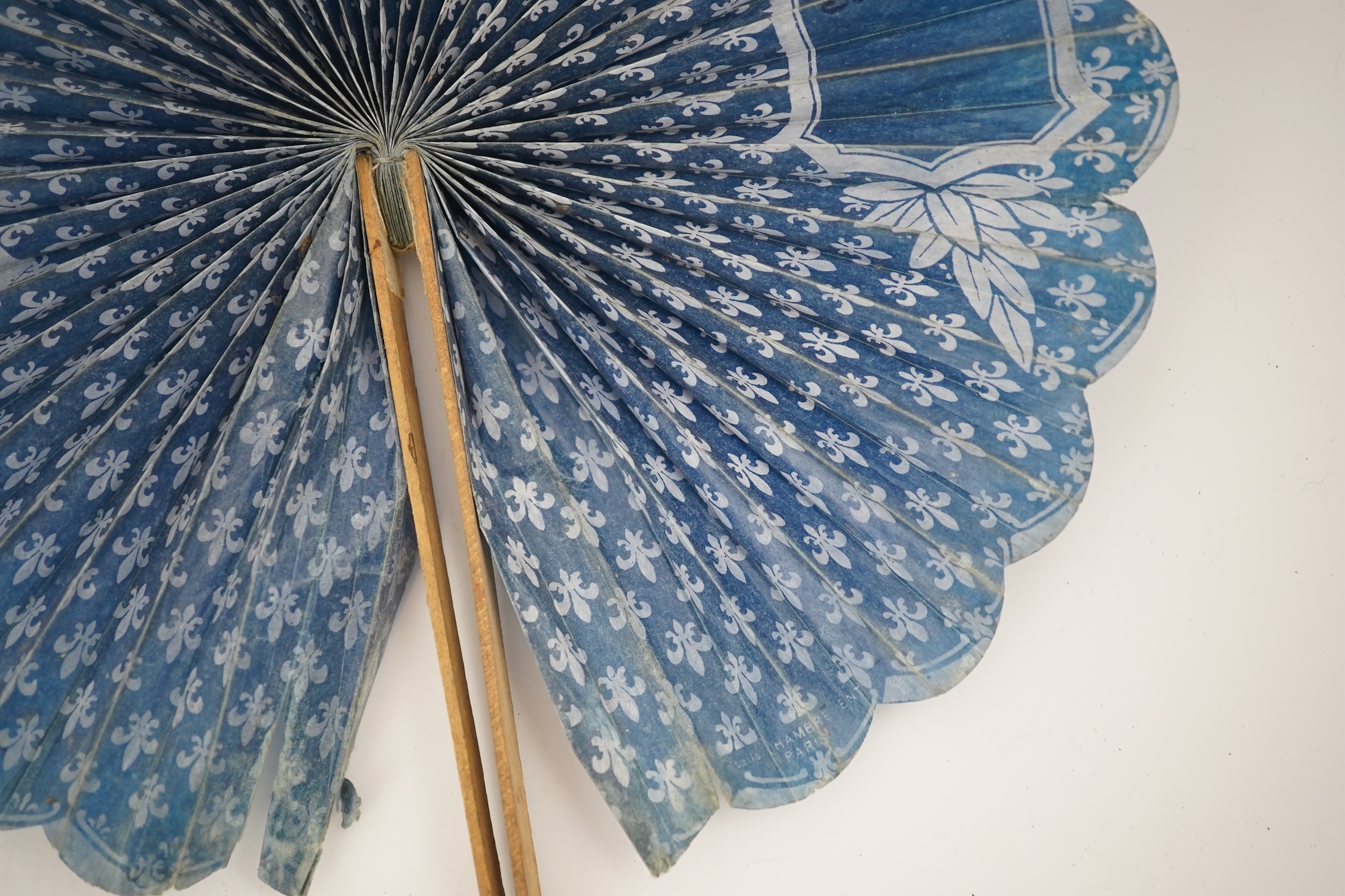 Three novelty fans with a mixed Brussels lace fan and black lace fan, a small language of love in flowers fan, a paper windmill advertising French Café fan, a carved cream Bakelite fan, a black and gilt, lace and sequin